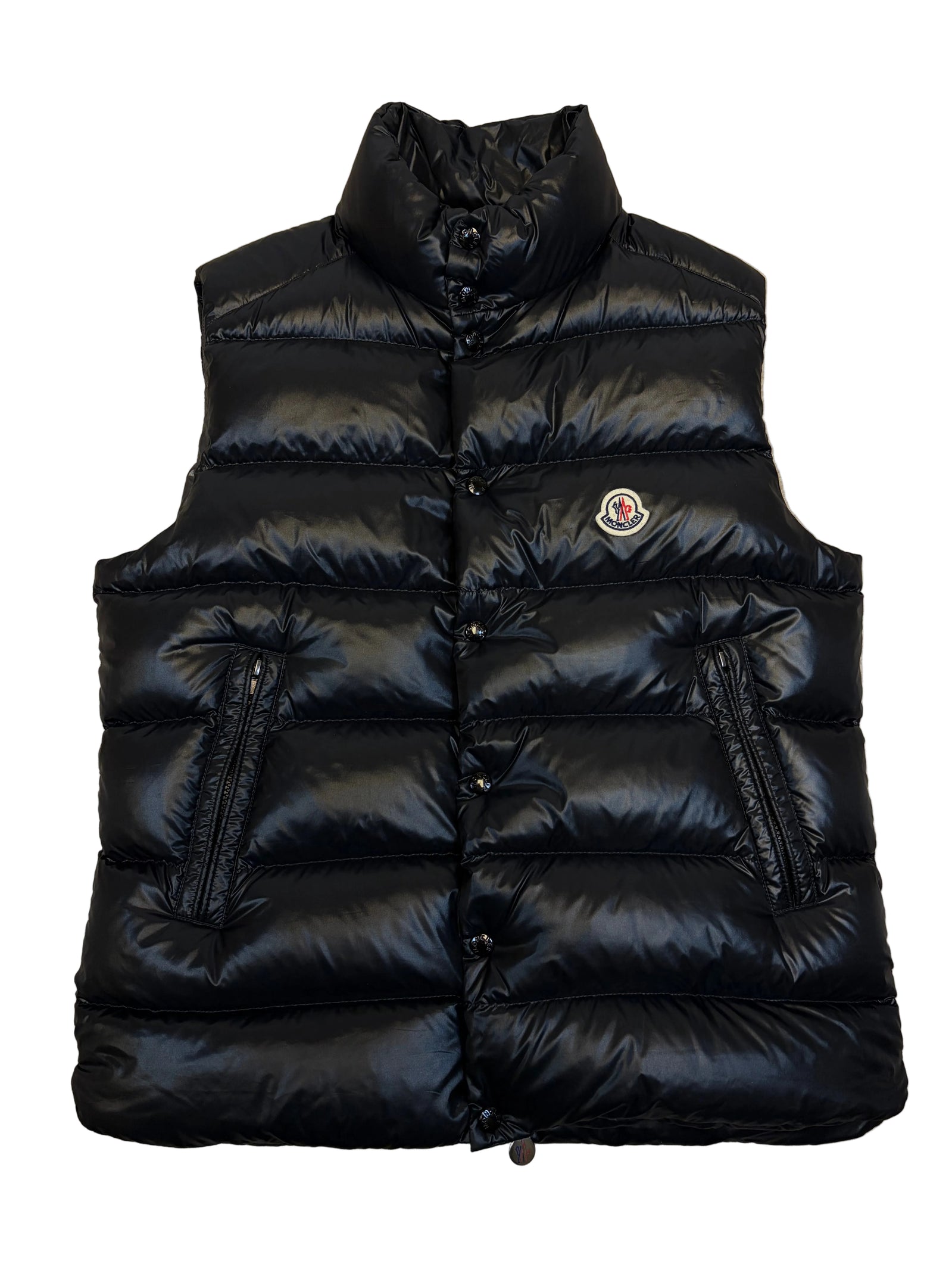 Black puffer jacket on a beige carpet