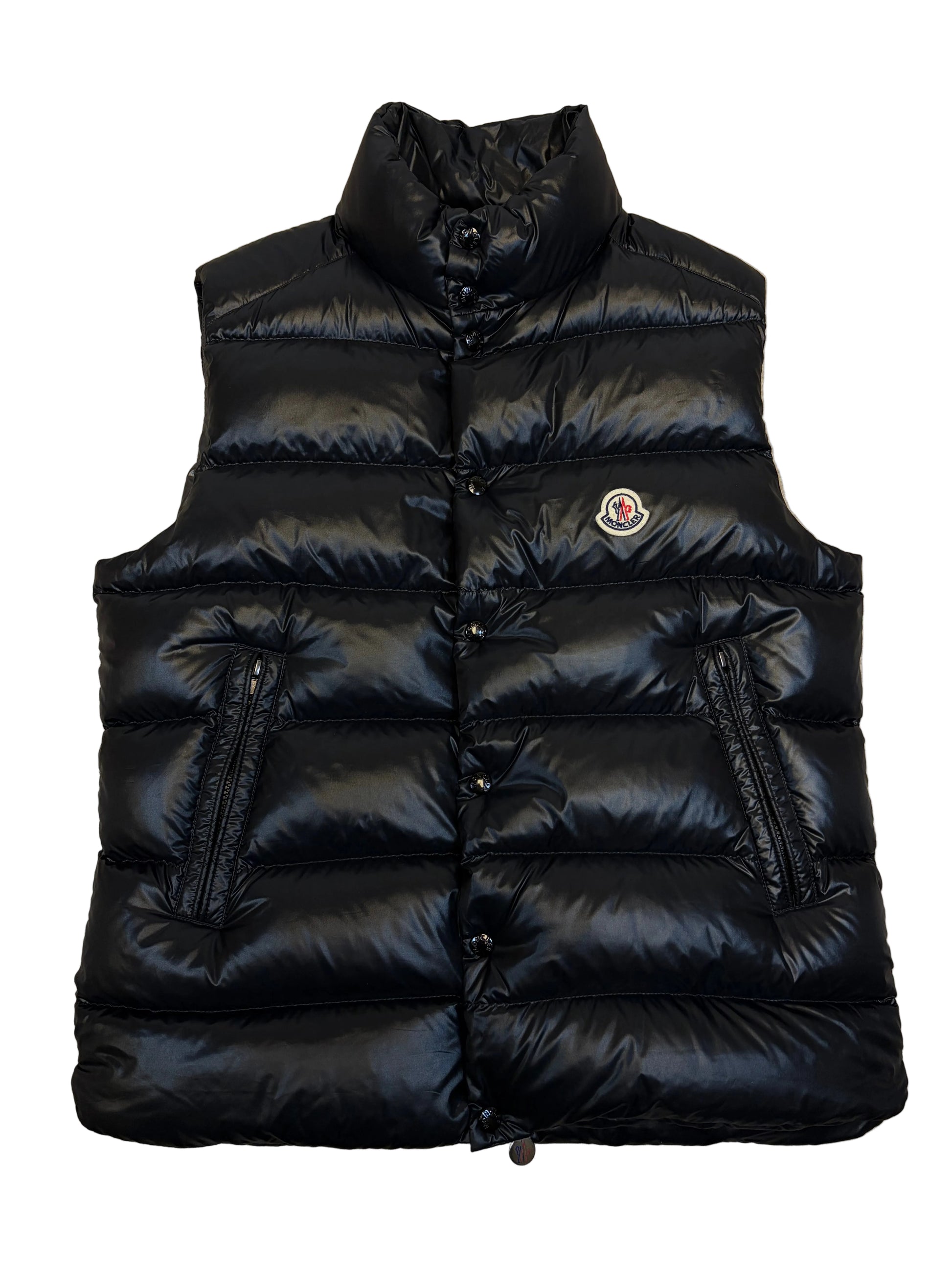 Black puffer jacket on a beige carpet