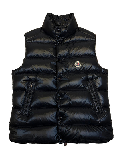 Black puffer jacket on a beige carpet