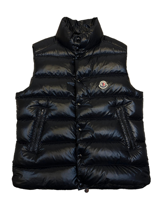 Black puffer jacket on a beige carpet