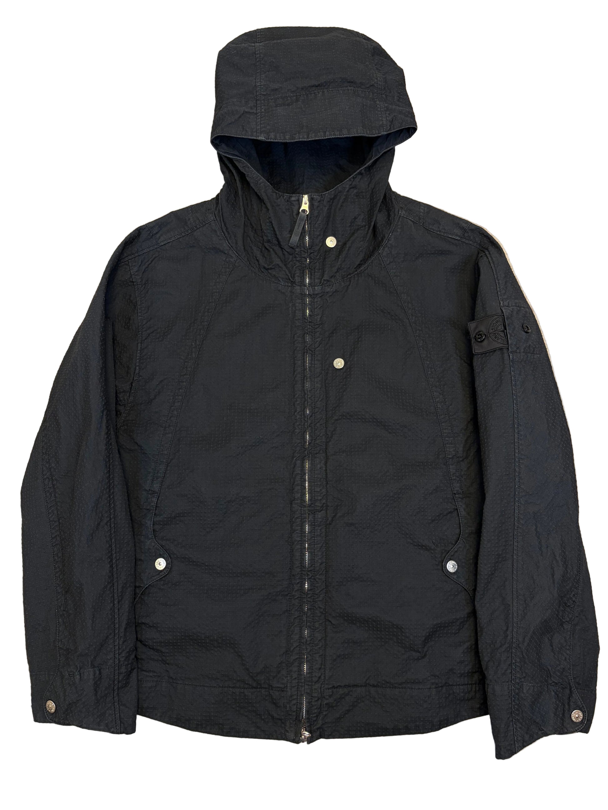 Black jacket on a beige surface