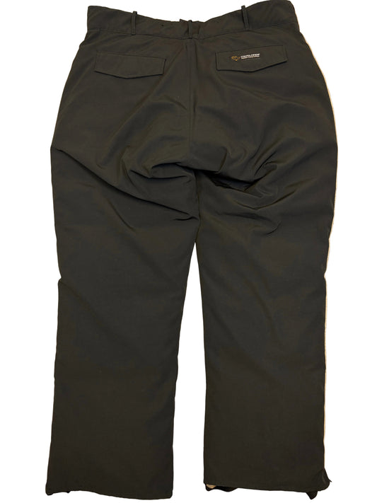 Black pants laid flat on a beige surface