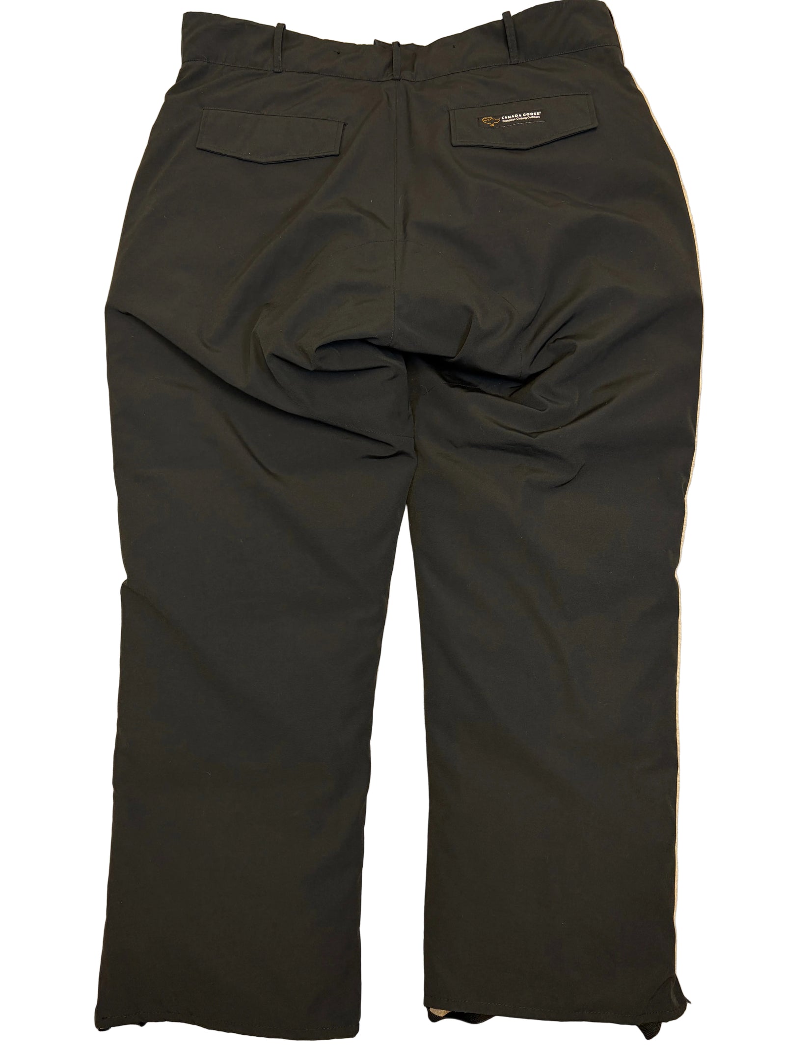 Black pants laid flat on a beige surface