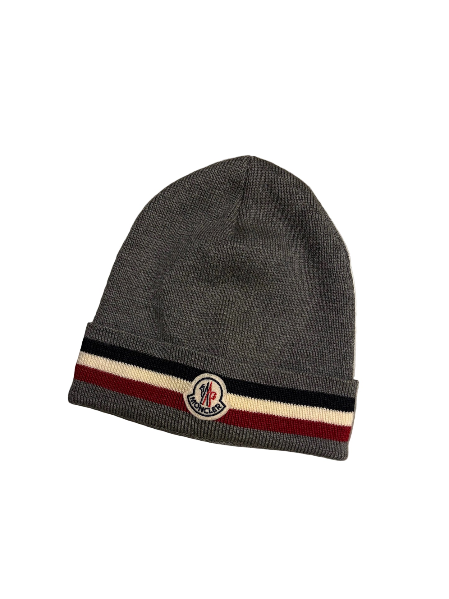 Gray beanie with a striped band and logo on a concrete surface
